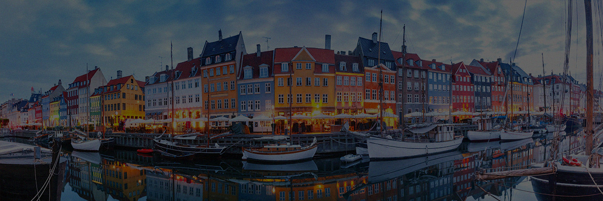 Panoramic view of Nyhavn waterfront in Copenhagen, featuring colorful buildings and boats, used as a banner for JSA at the IBA Annual Conference 2026.